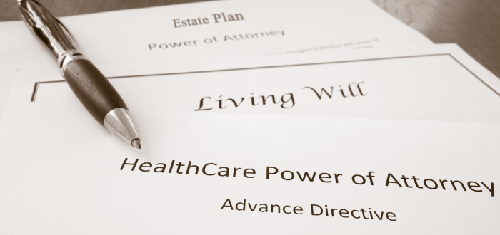 Stack of papers containing the power of attorney, estate plan, and living will