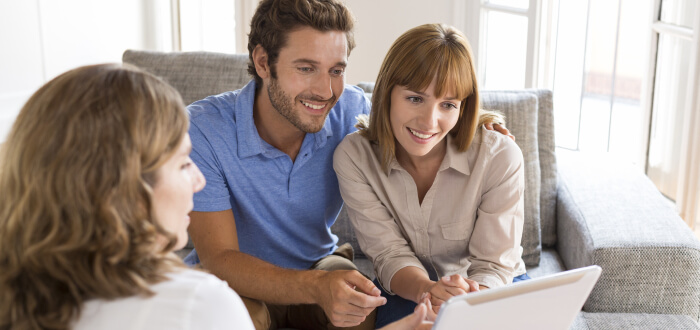 Estate planning with a couple while the lawyer shows them documents