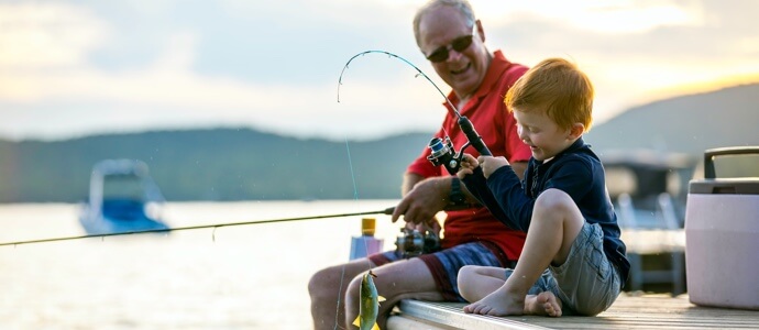 Grandfather fishing with grandson