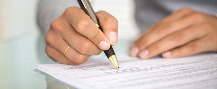 Woman signs a document