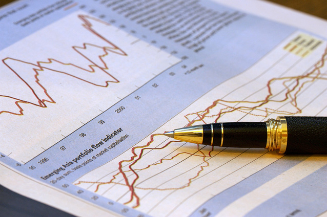 A pen laying on a paper with the market graph