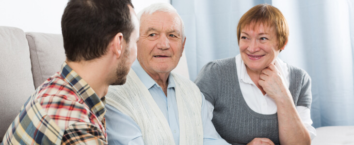 An older couple speaks with a man